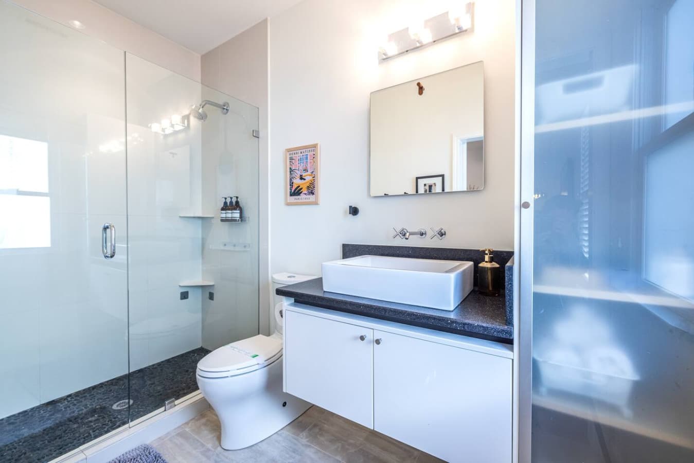 Relax and refresh in a bright, thoughtfully styled primary bathroom.
