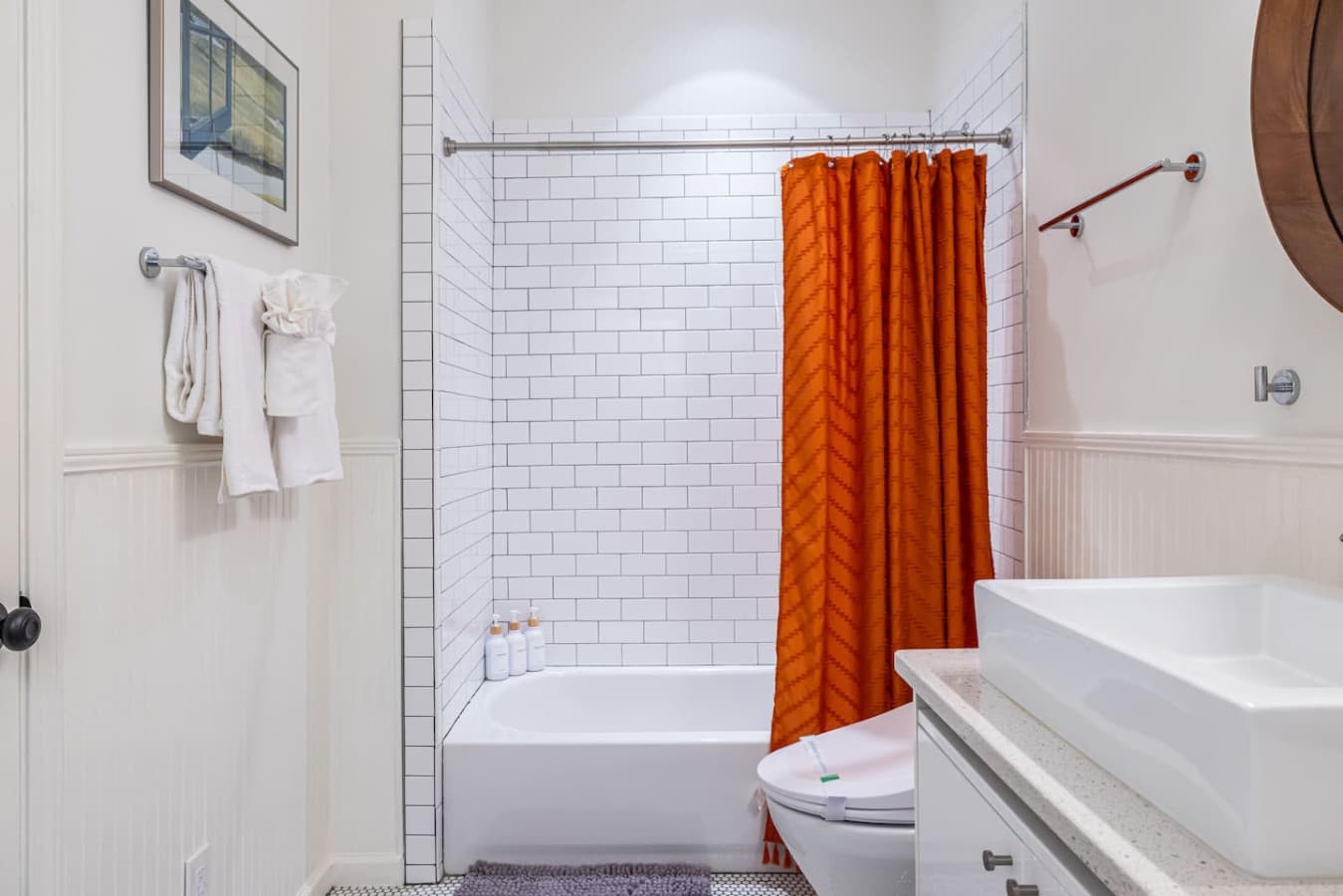 A crisp, airy bathroom with sleek lines and thoughtful details, including a bidet.