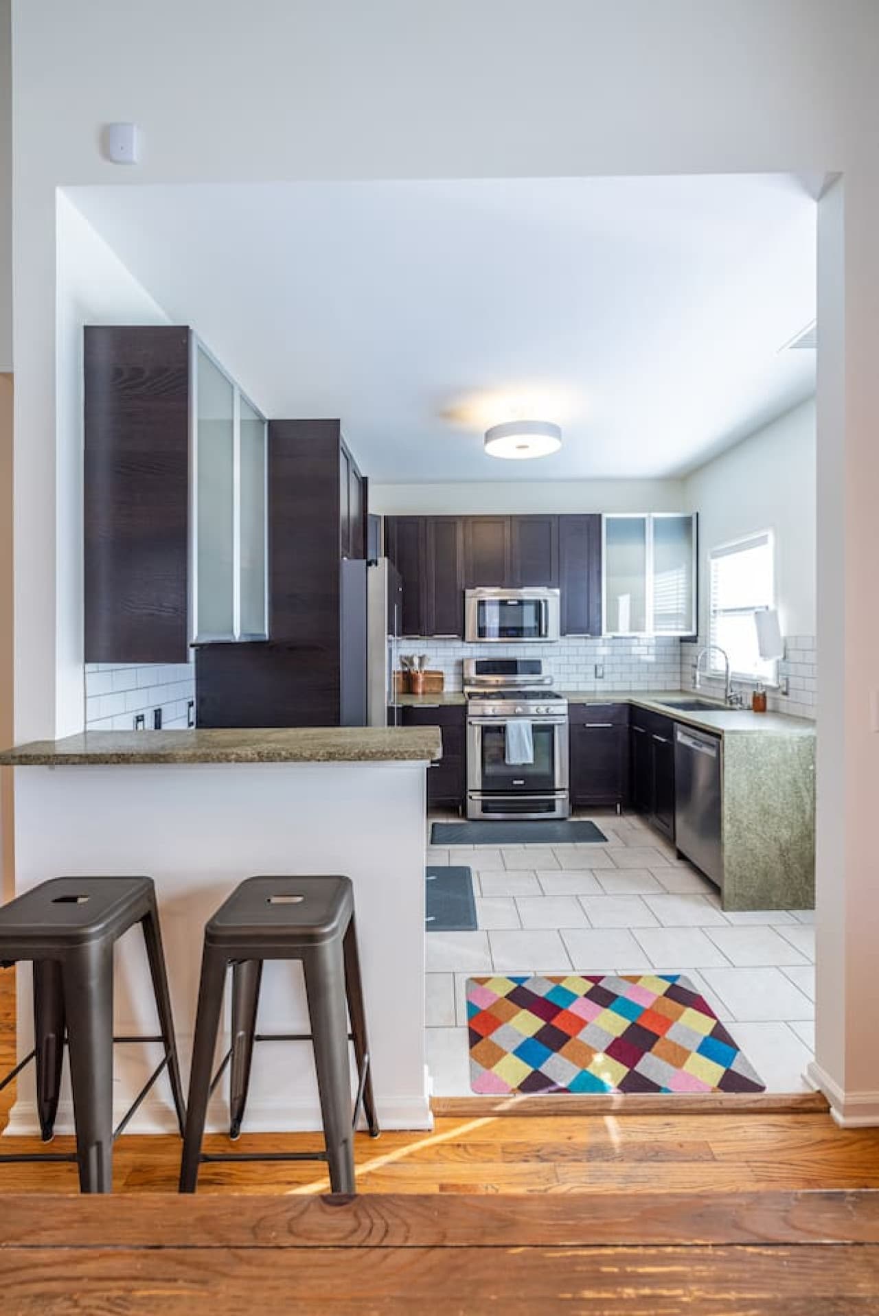 An open flow from dining to kitchen, with a breakfast bar for casual meals or morning coffee.