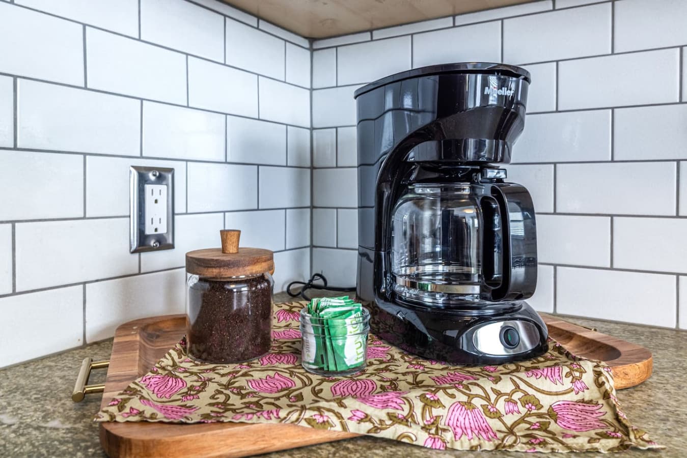 Enjoy fresh coffee anytime from the fully stocked coffee station.