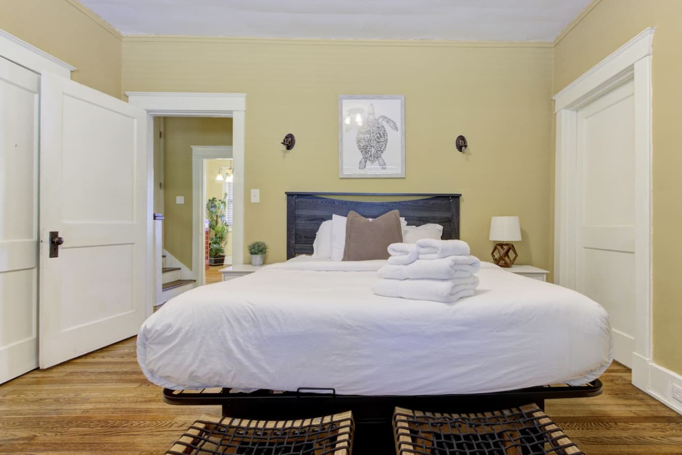 Spacious queen bed with fresh linens and soft lighting for a restful night’s sleep.
