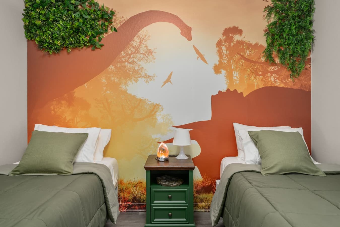 Green dino vibes and twin beds made for fun, comfort, and imagination.