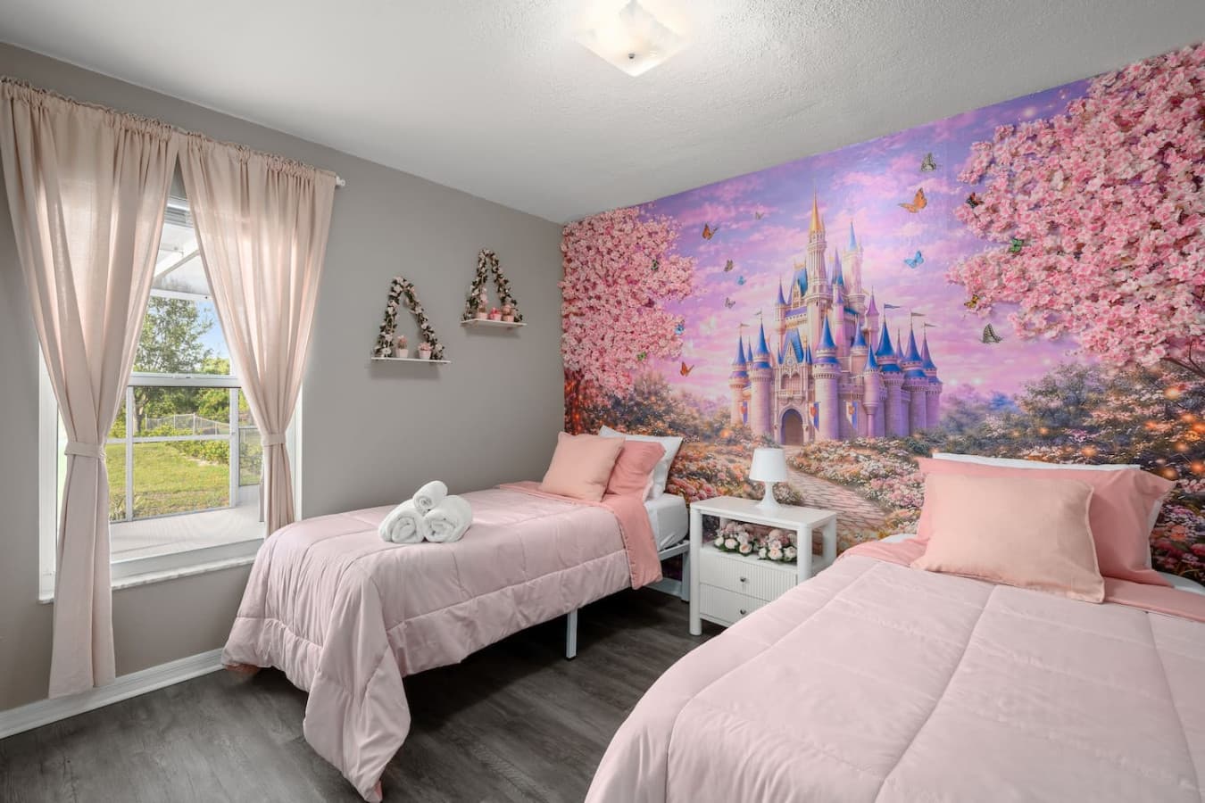 A pink princess-style room with two single beds made for sweet dreams and shared giggles.