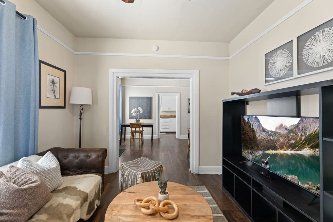 The living area, featuring a Smart TV, flows seamlessly into the dining and kitchen areas, creating an inviting and cohesive environment.