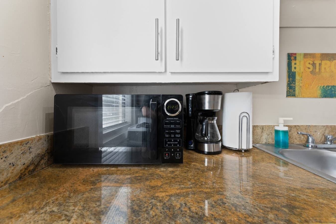 Convenient microwave and coffee maker for a quick bite or a fresh cup to start your day.