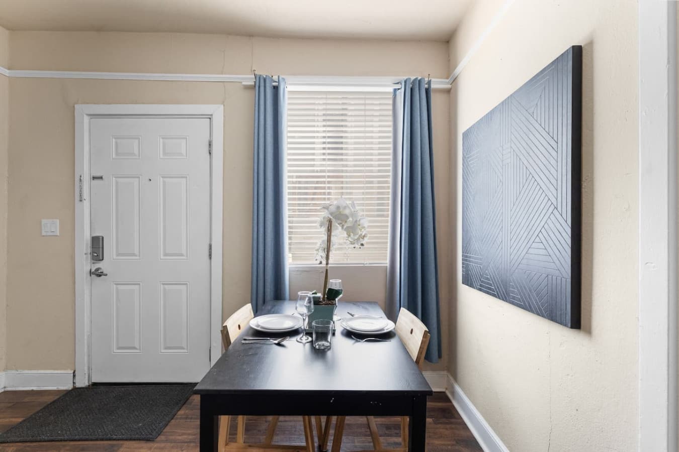 Cozy table for two, bathed in ample natural light, perfect for meals or a quiet moment.