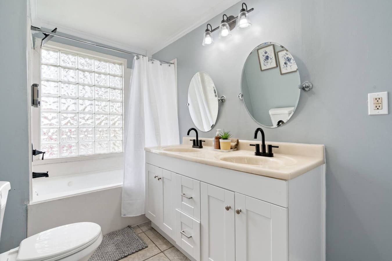 This upstairs bathroom keeps everything simple and convenient for guests with jetted bath tub.