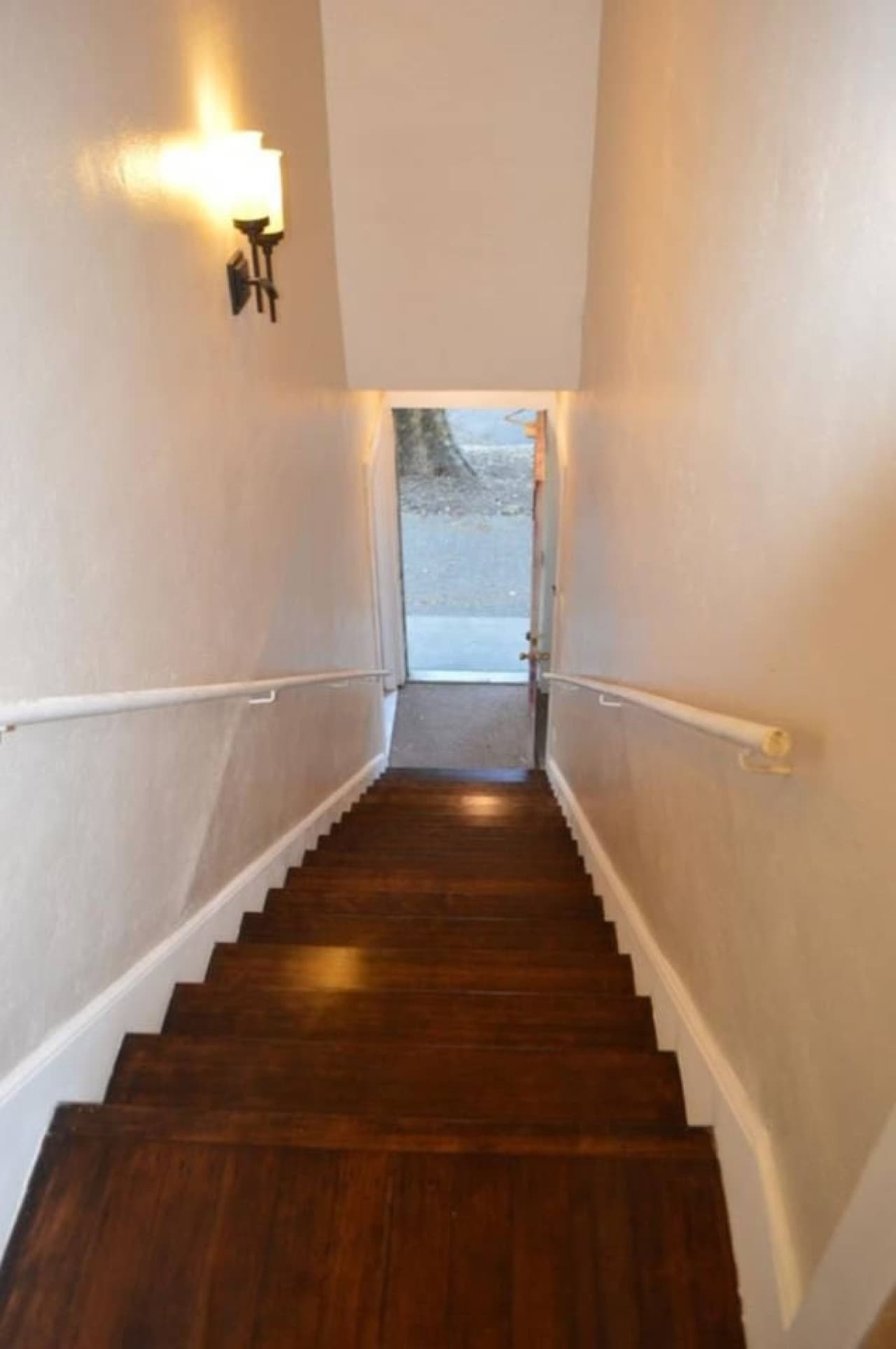 Stairs leading up to the apartment, accessed from the front of the building.