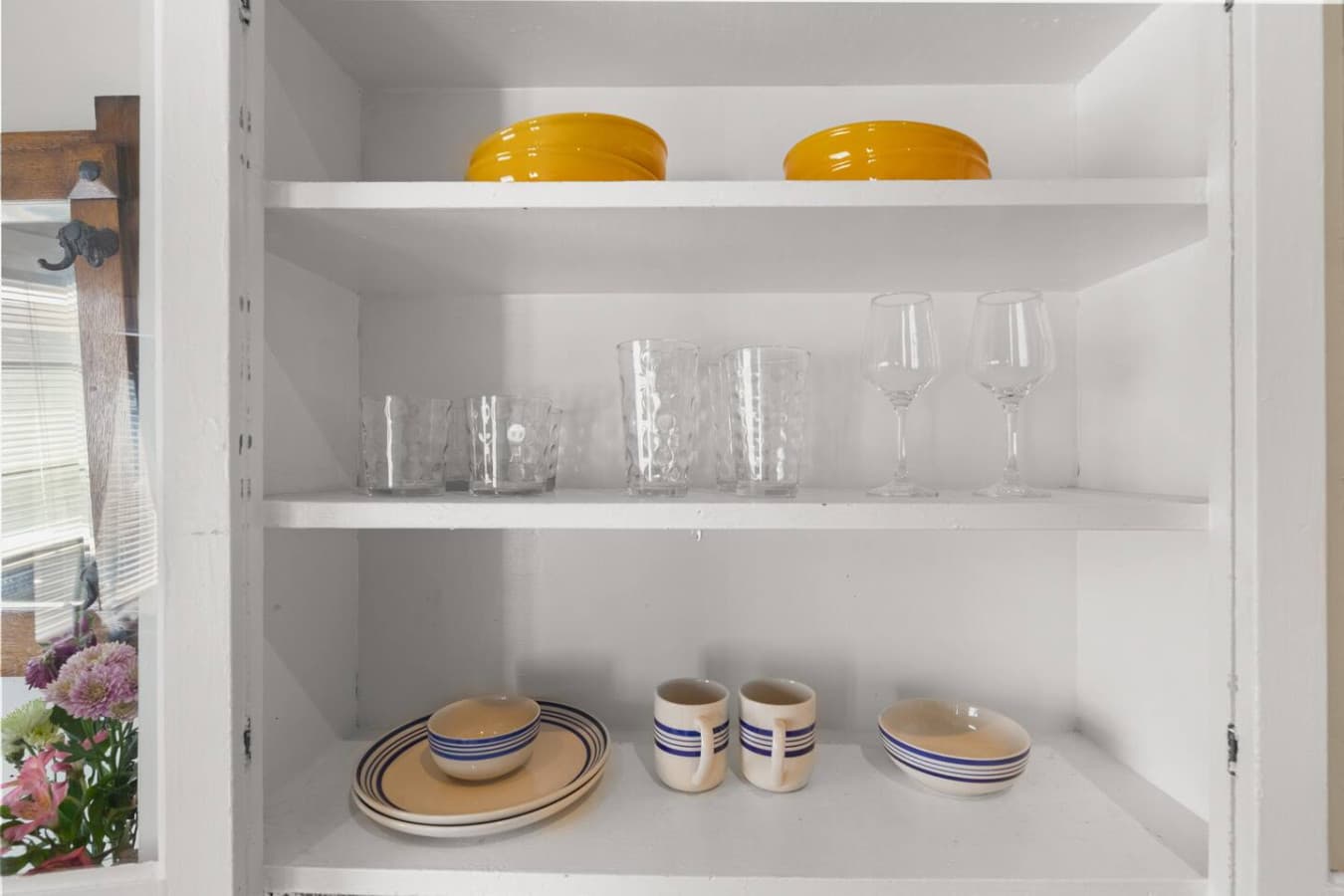 Shelving with plates, mugs, and glasses available for your use.
