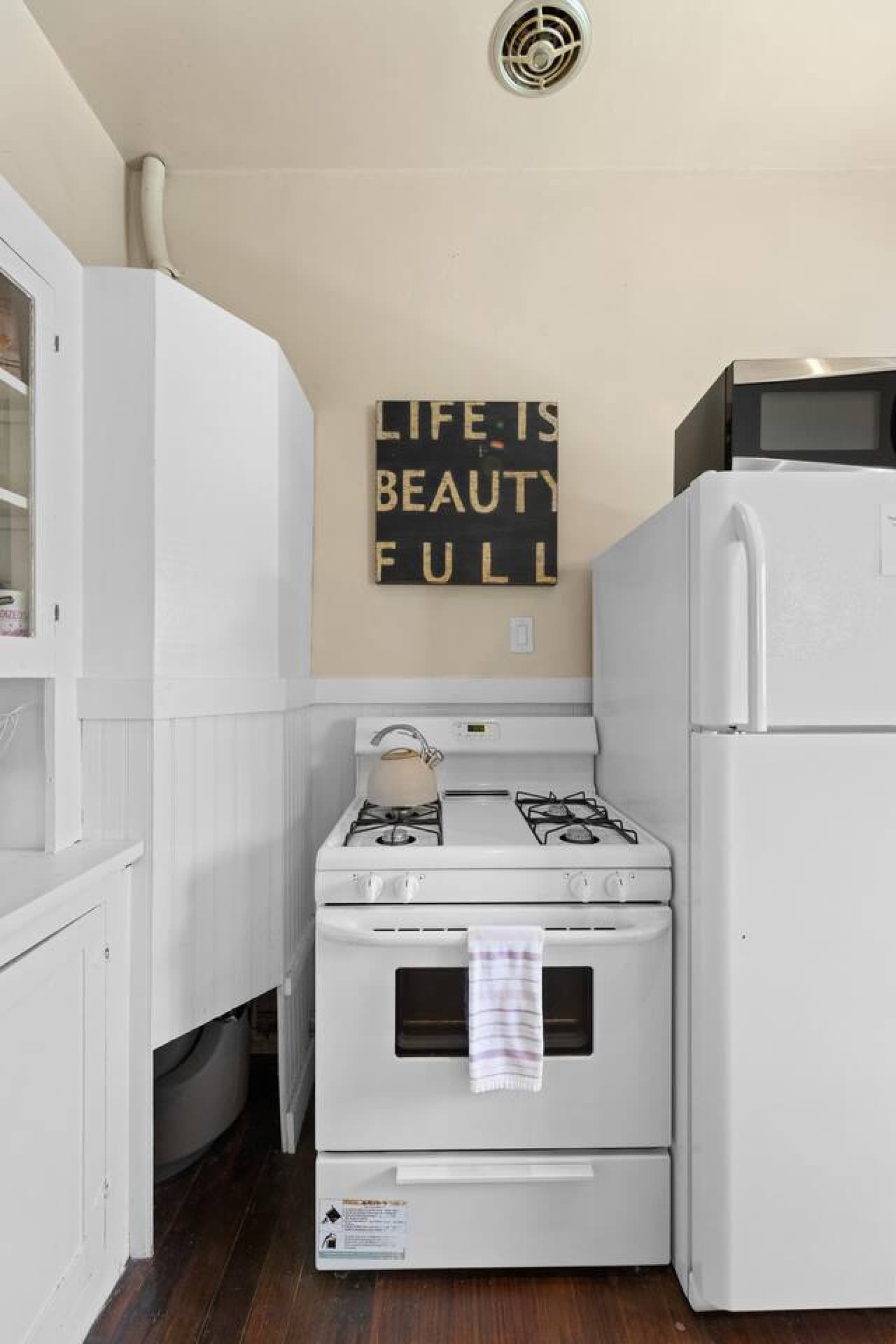 Cooking space with stove, fridge, and microwave for your convenience.