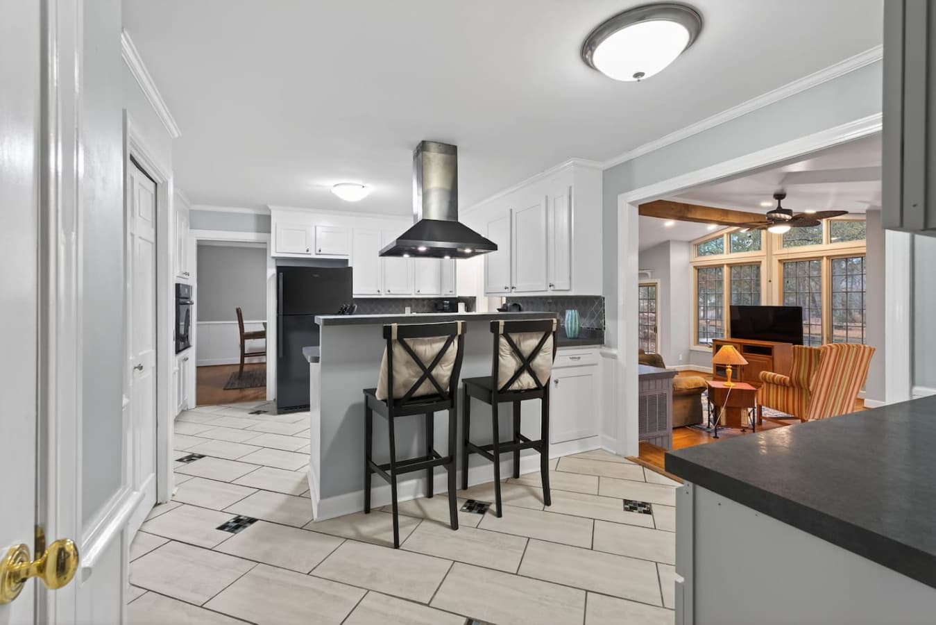 Modern kitchen with bar seating, ample counter space, and essential appliances