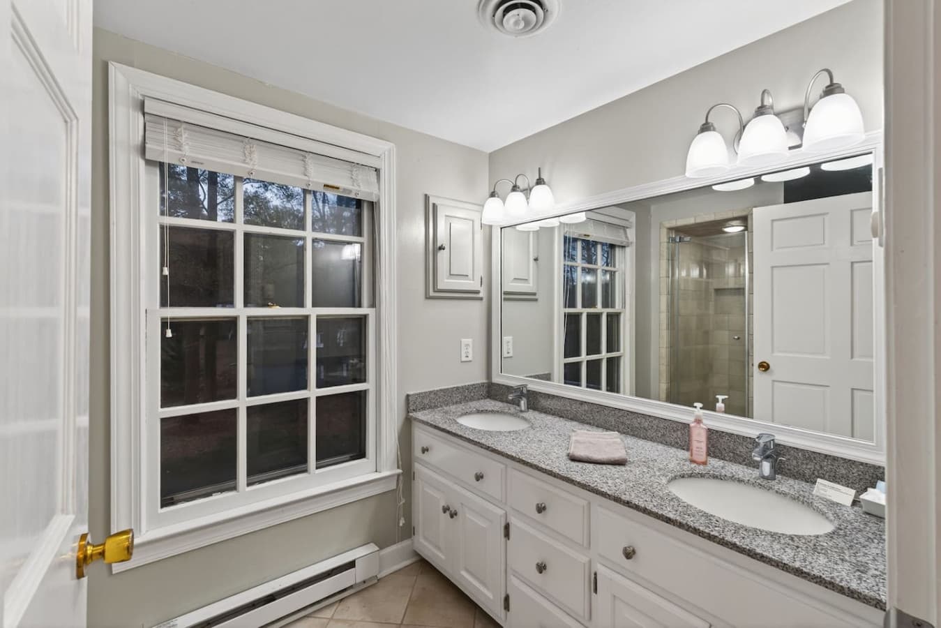 A private ensuite with double sinks and a refreshing shower—perfect for a smooth morning routine.