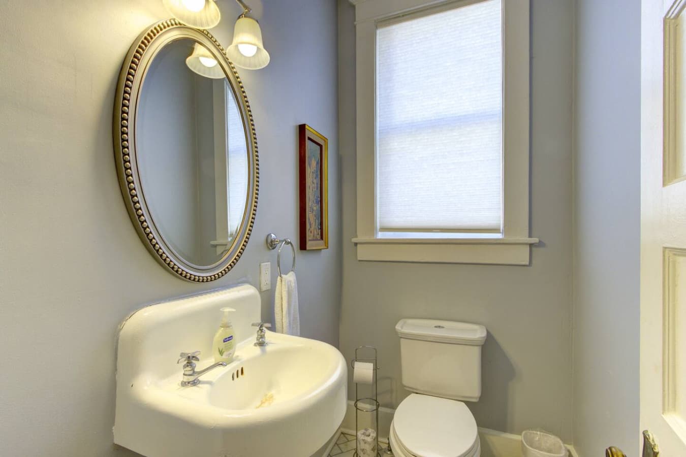 Half bathroom with a sink and a mirror.