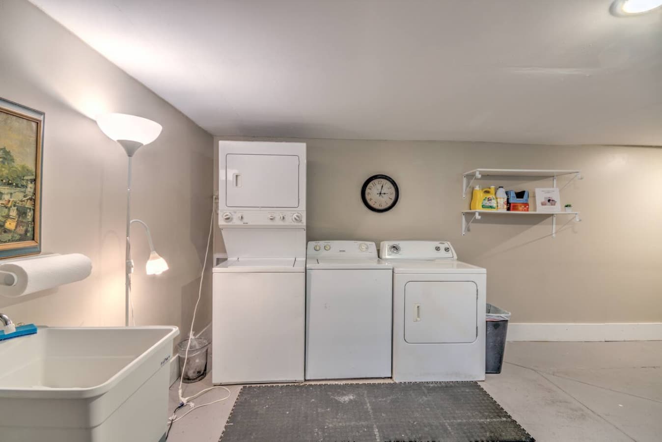 Shared laundry room in the basement with two washer and dryer sets, plus complimentary soaps provided.