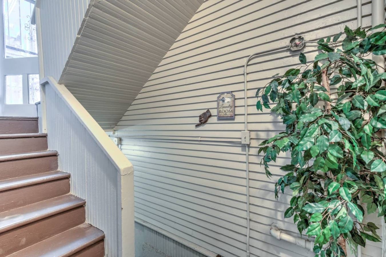 Stairs leading down to the finished basement laundry area—soap provided for your convenience.