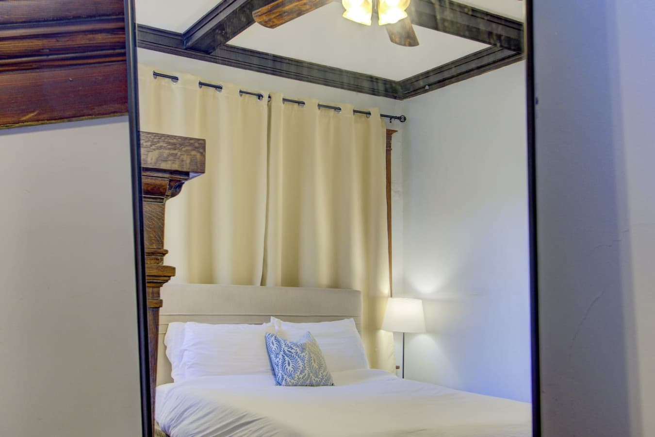Spacious bedroom with vintage wood details, cozy lighting, and plenty of charm, a comfortable retreat to unwind in.