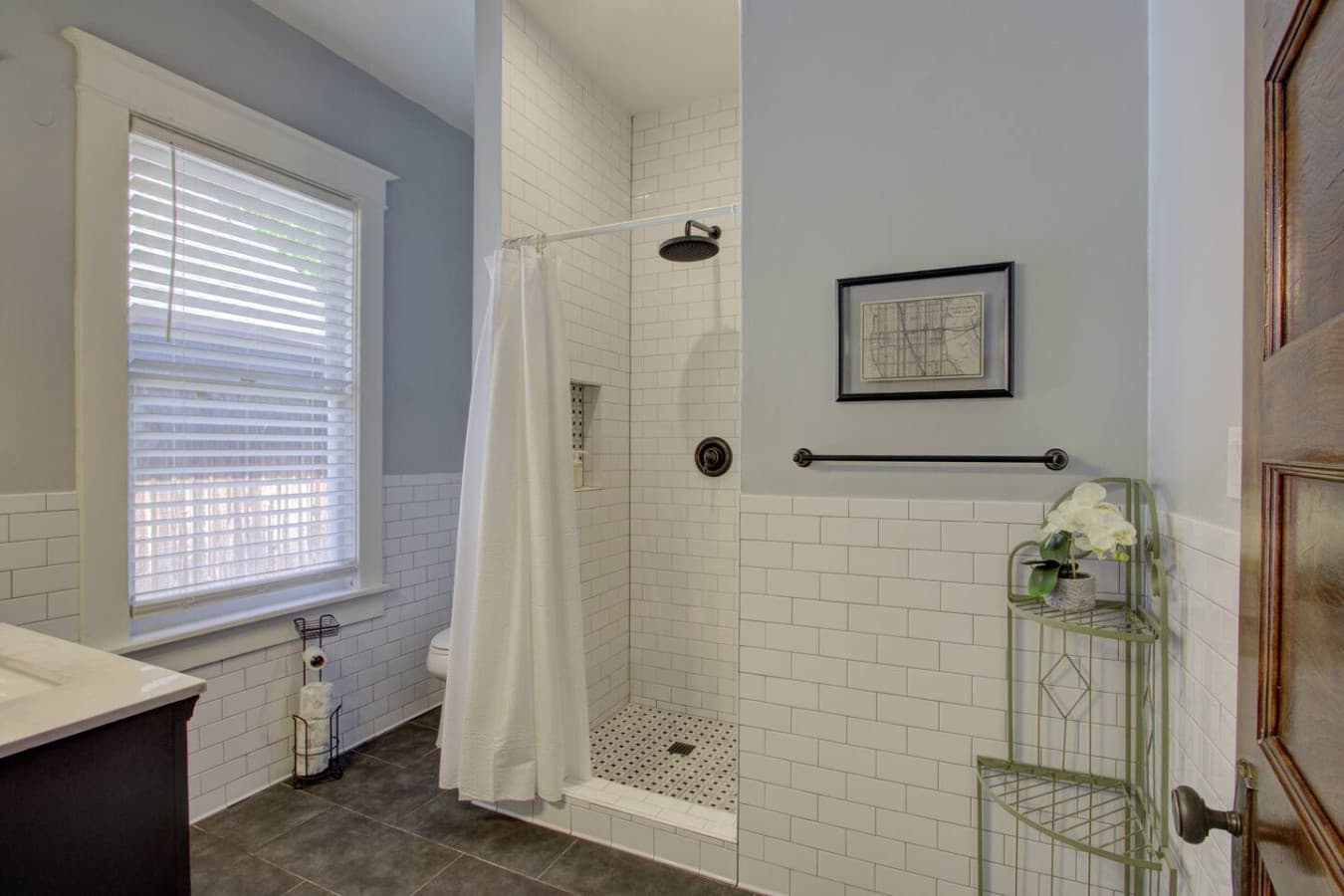 Bright bathroom with a spacious walk-in shower, modern fixtures, and fresh towels, designed for comfort and convenience.