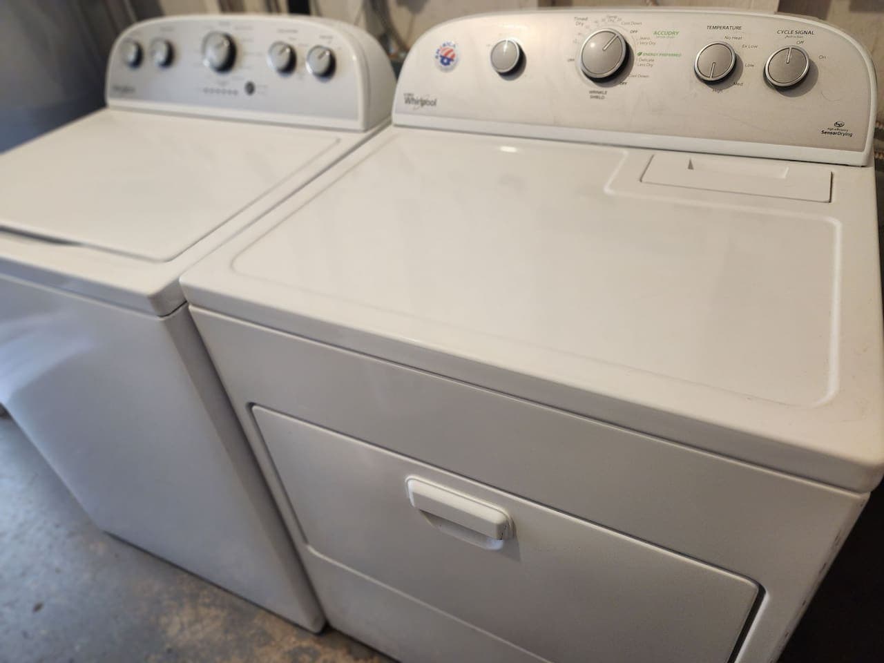 Full service washer and dryer with laundry supplies.