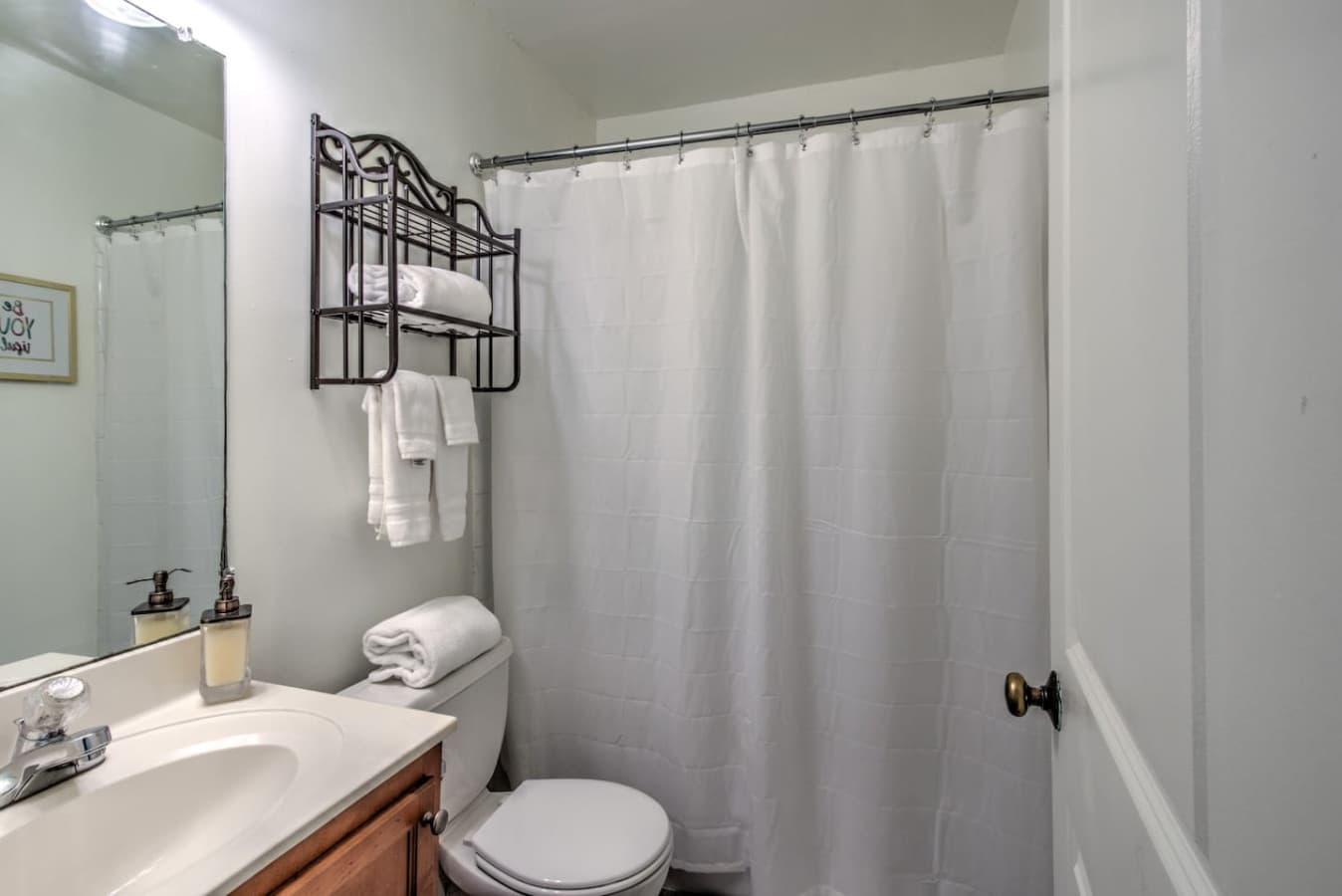 Full-size bathroom with tub and all the essentials (shampoo, soaps, and towels)