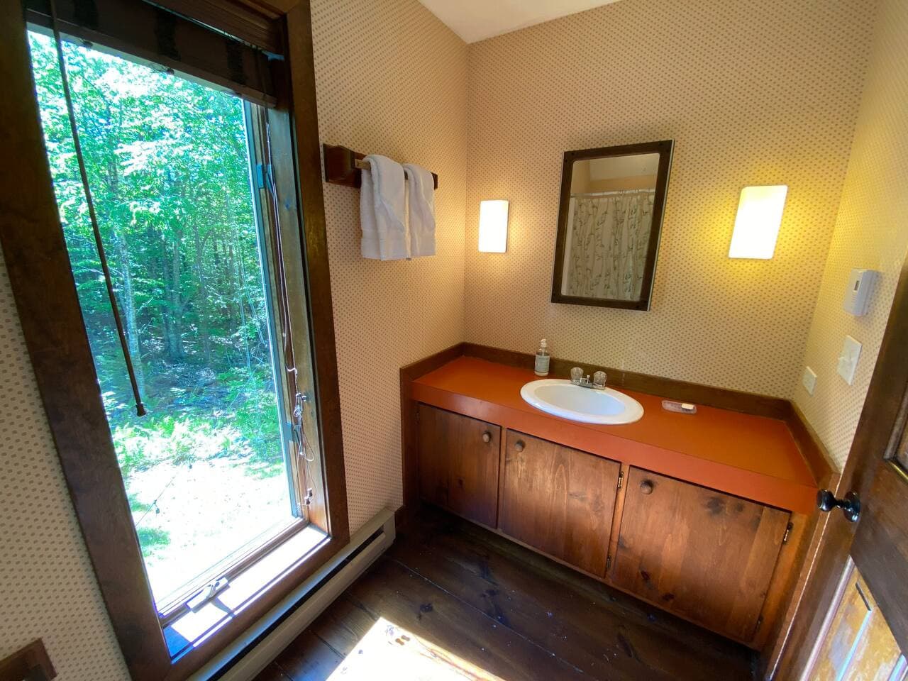 Enjoy the natural light streaming through the windows as you refresh in this serene and well-appointed bathroom.