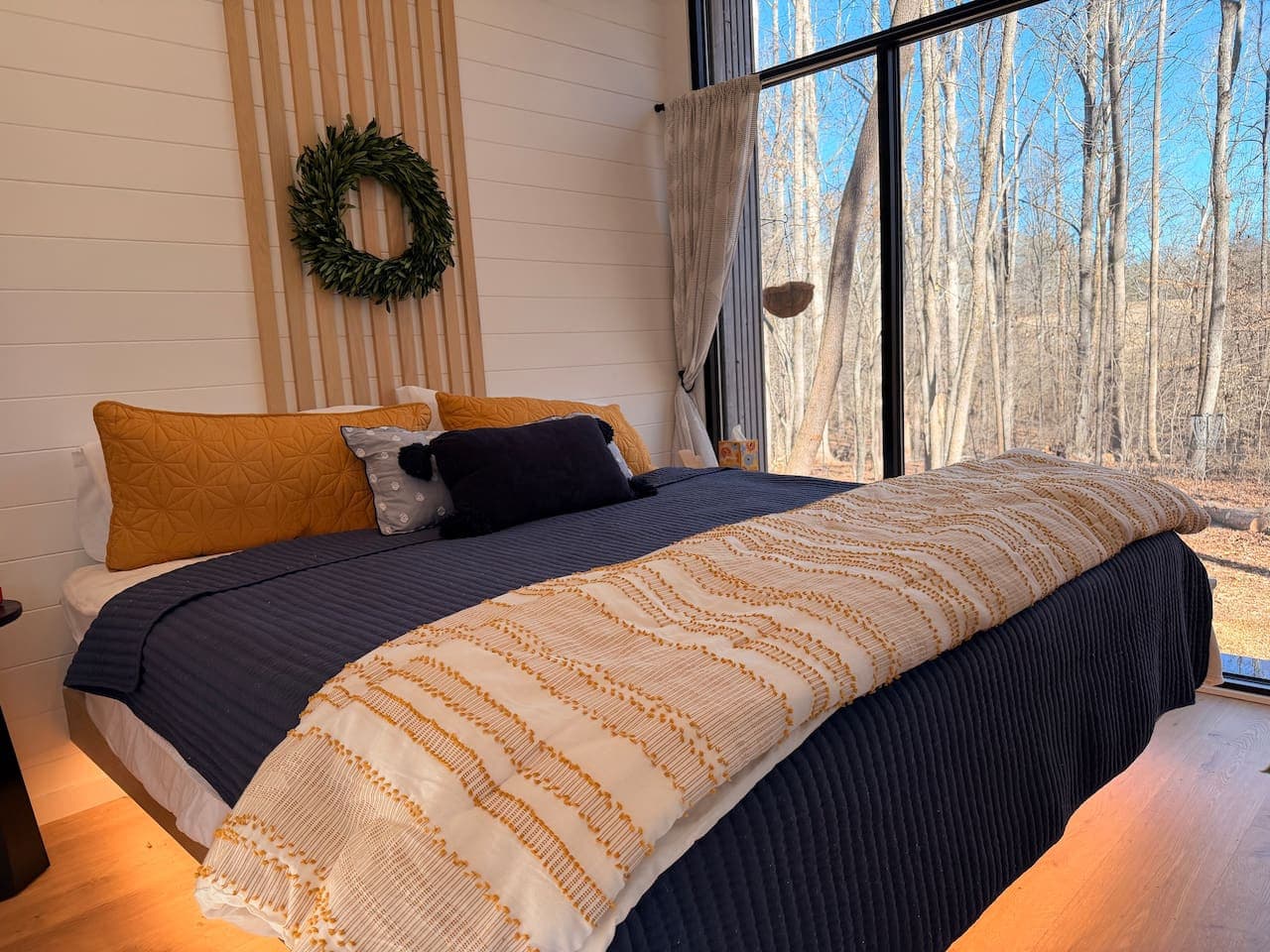 Luna Studio: Relax and rest in this peaceful sleeping area with a custom oak floating king bed and calming lighting.