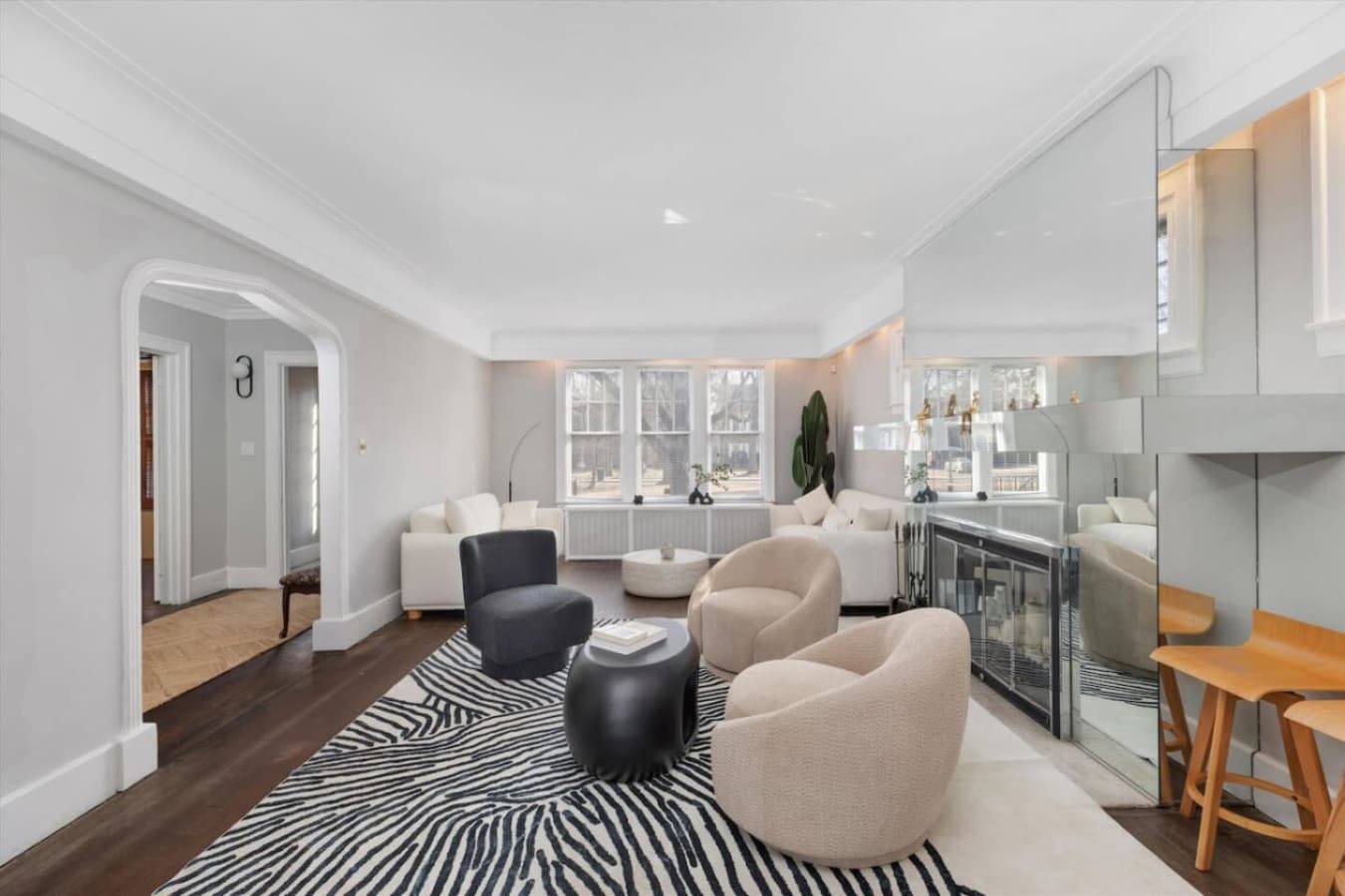 Modern furnishings and a striking mirror create a bright, inviting spot to unwind or catch up with the group.