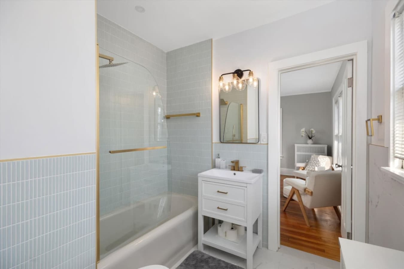 A modern, well-lit bathroom with a tub/shower combo, perfect for starting or ending your day.