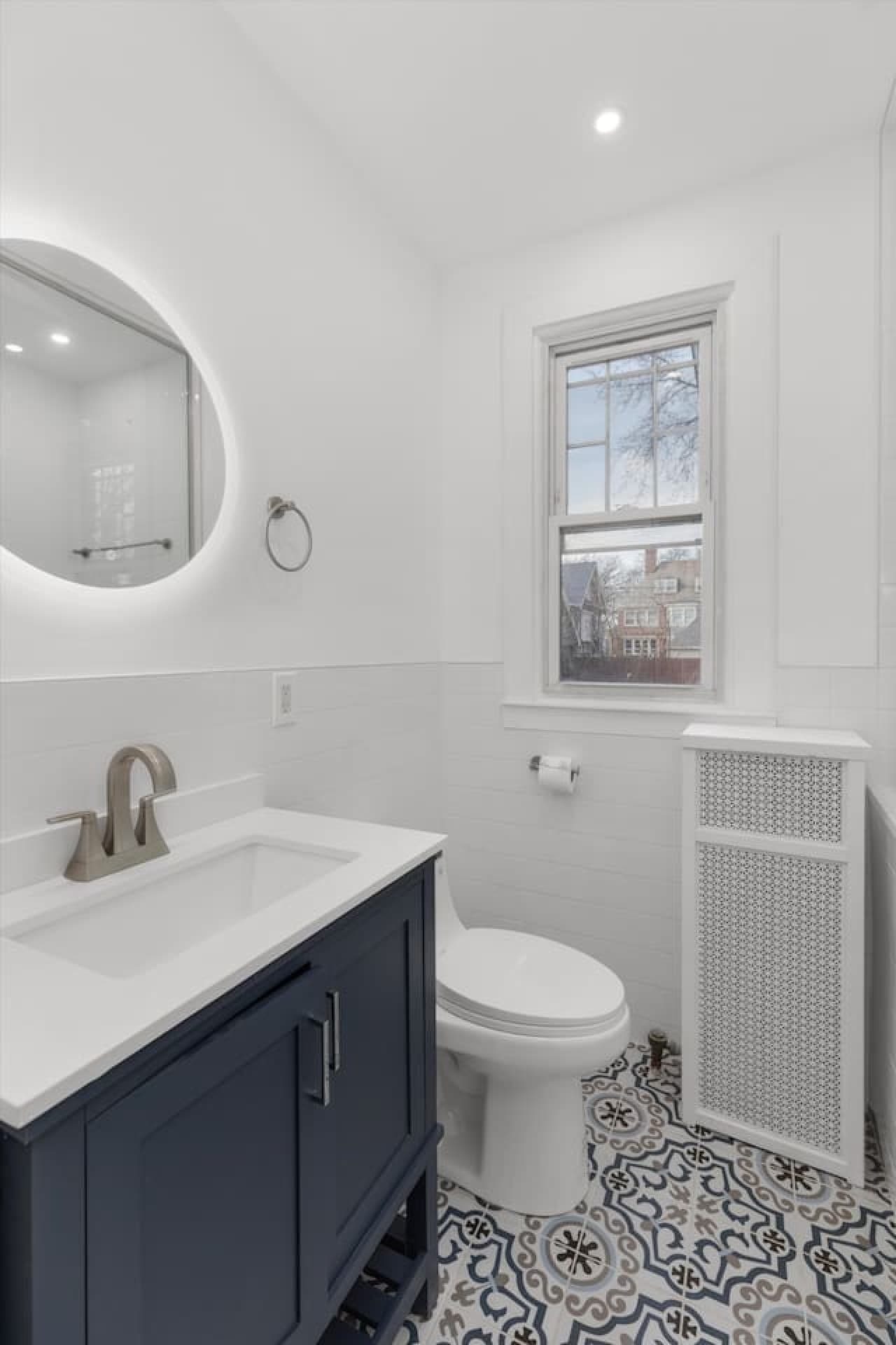 A spacious and sleek full bathroom, designed for both comfort and style.