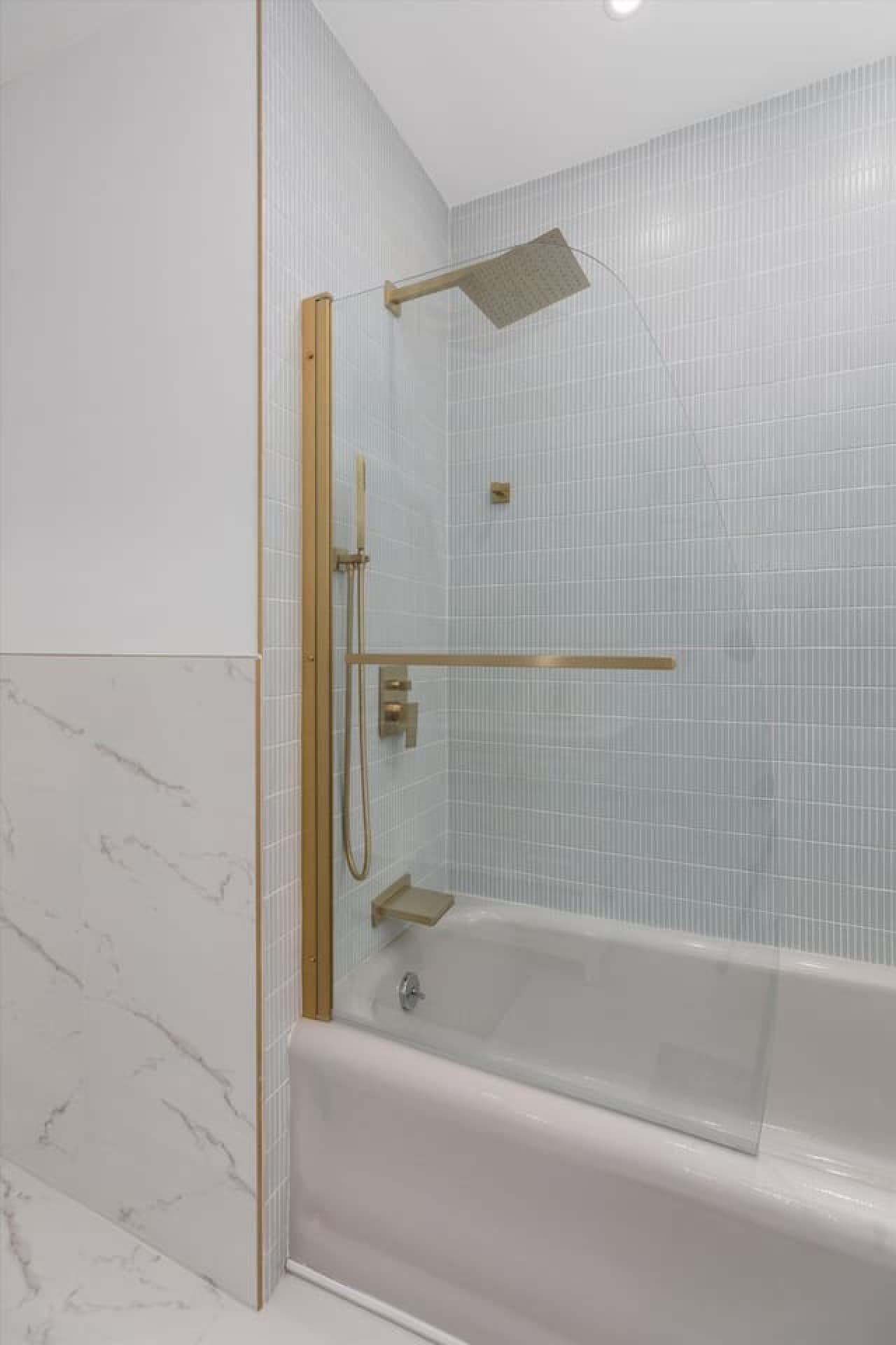 Step into a sleek, modern bathroom with a tub/shower combo and crisp, clean finishes.