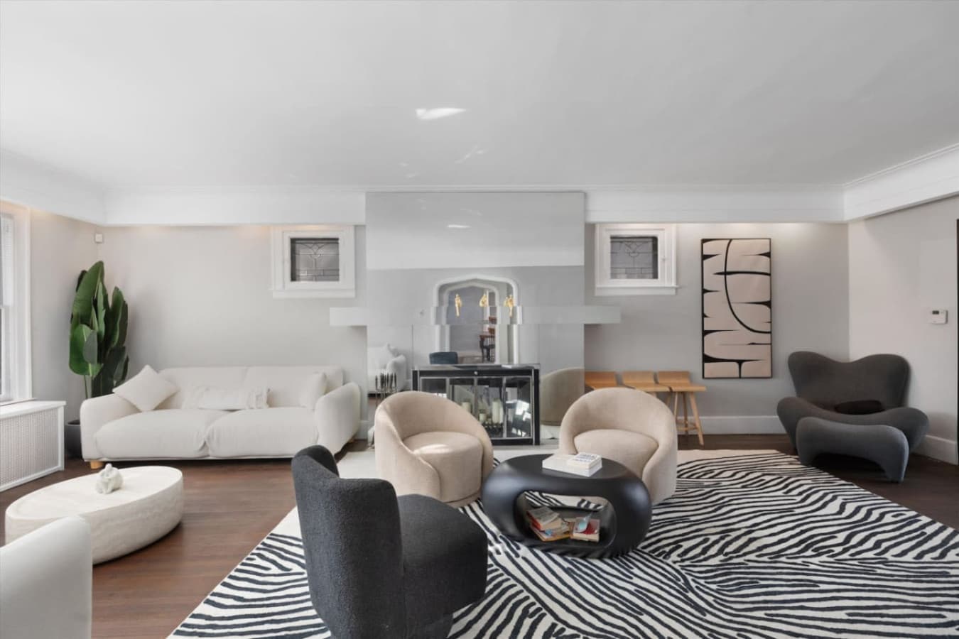 Clean lines, curated décor, and a large mirror that adds both light and character to this elegant sitting area.
