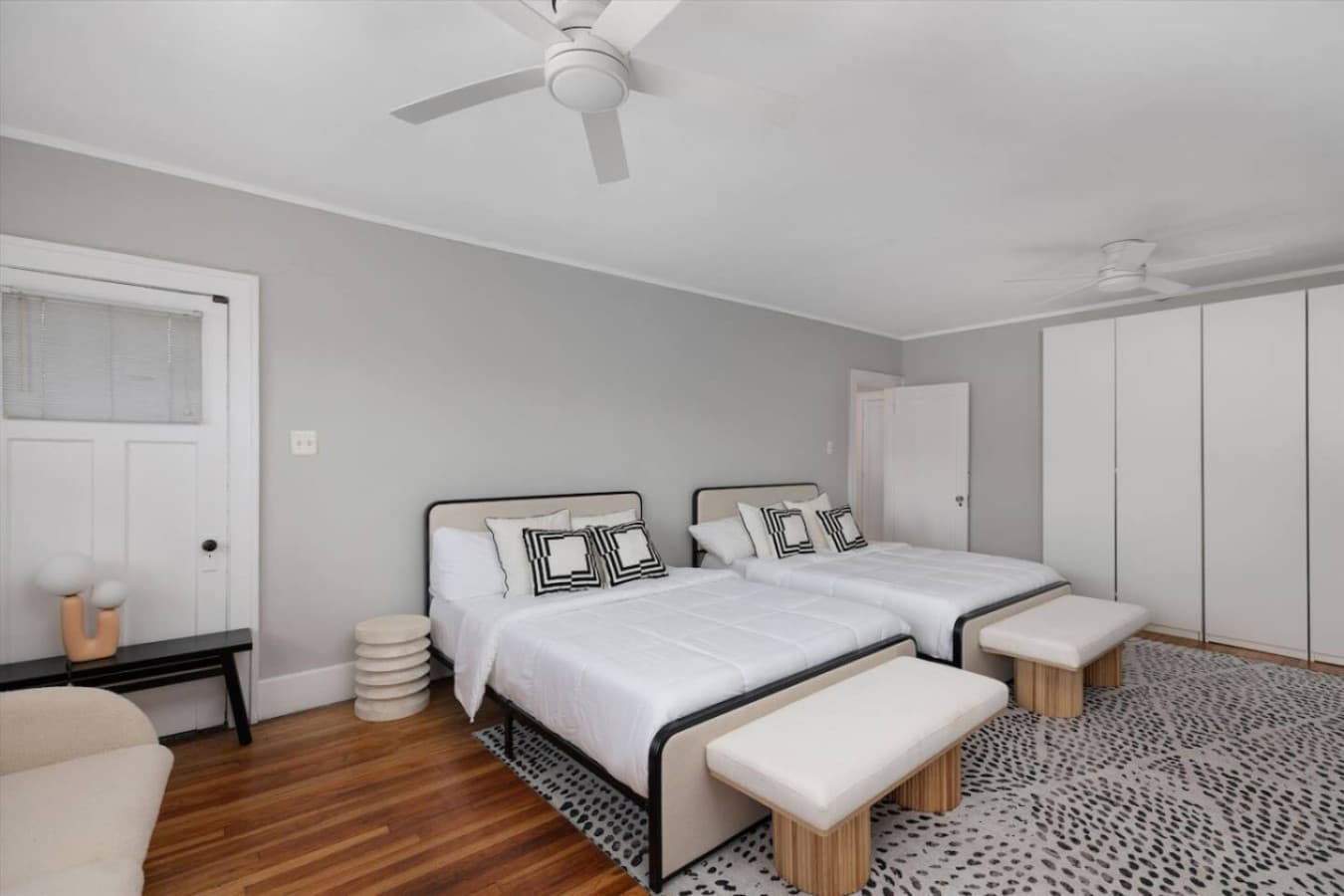 A bright, spacious room with two plush queen beds—perfect for friends or family sharing a space.
