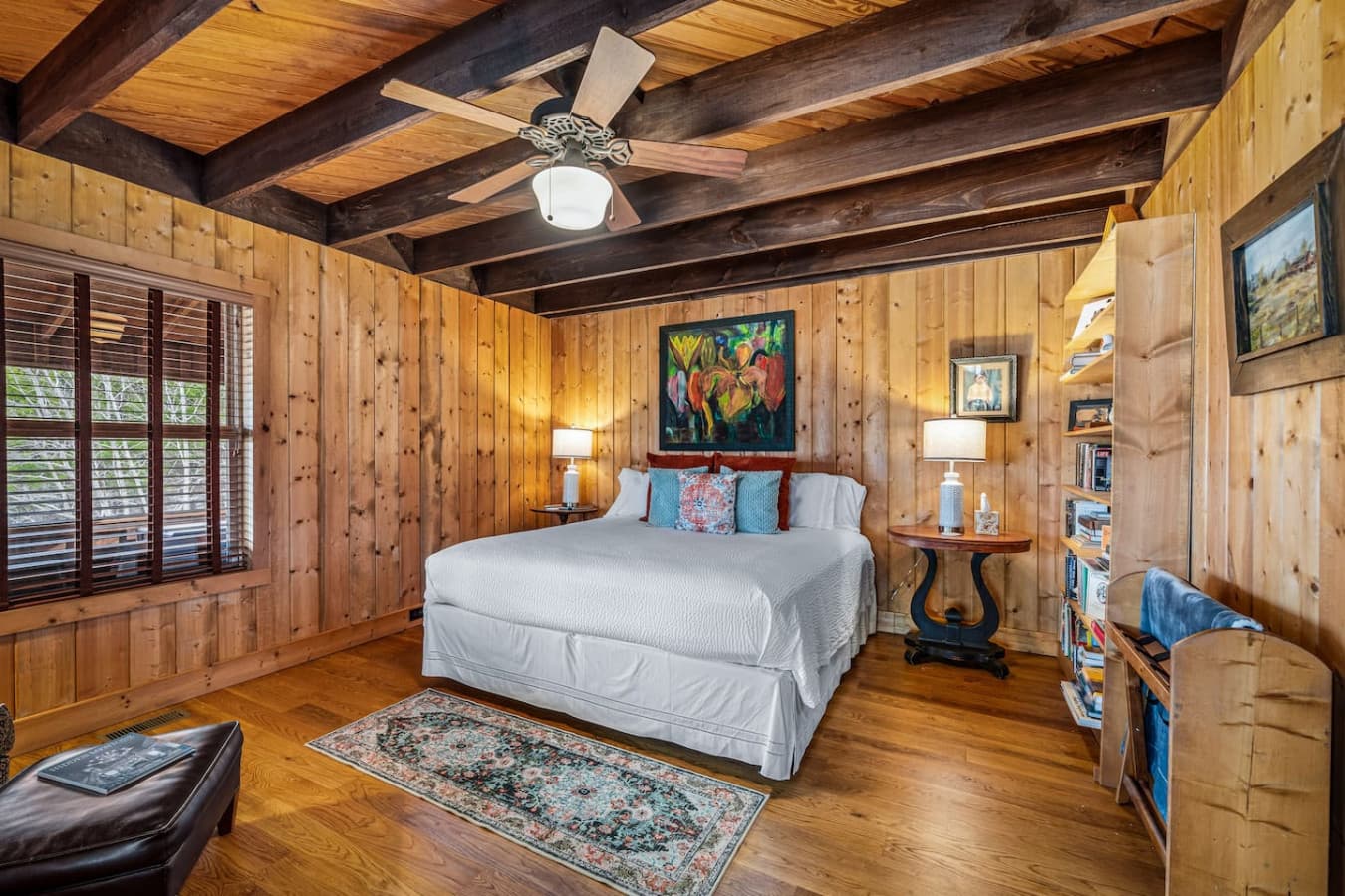 Bedroom 2 on the main floor with attached bathroom and stunning views, featuring a comfortable queen bed.