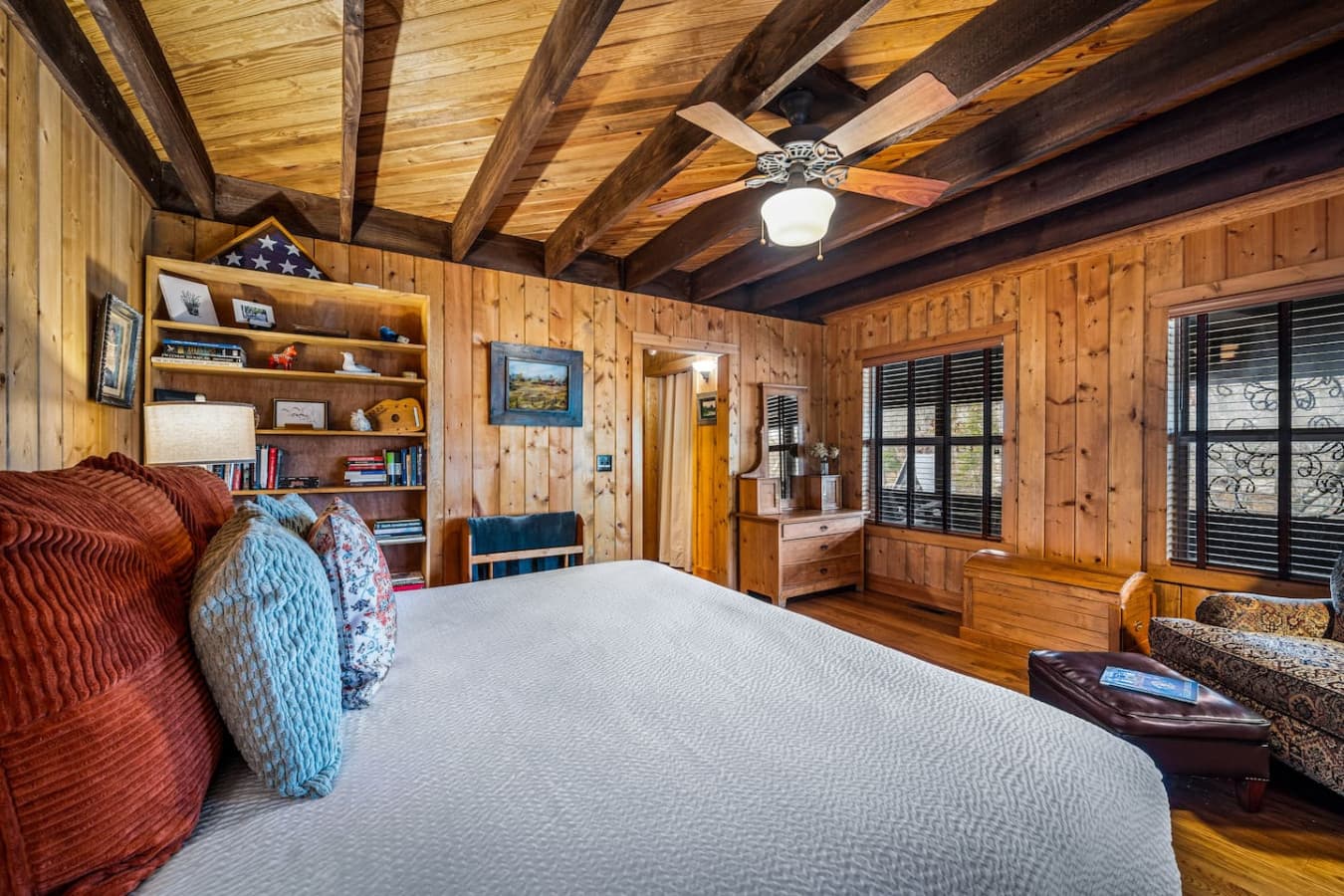 Bedroom 2 on the main floor with attached bathroom and stunning views, featuring a comfortable queen bed.