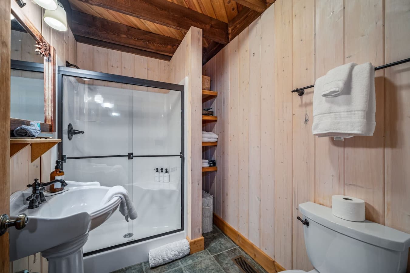 Bathroom 2, attached to Bedroom 2 on the main floor, featuring a shower and provided shampoo, conditioner, and body wash.