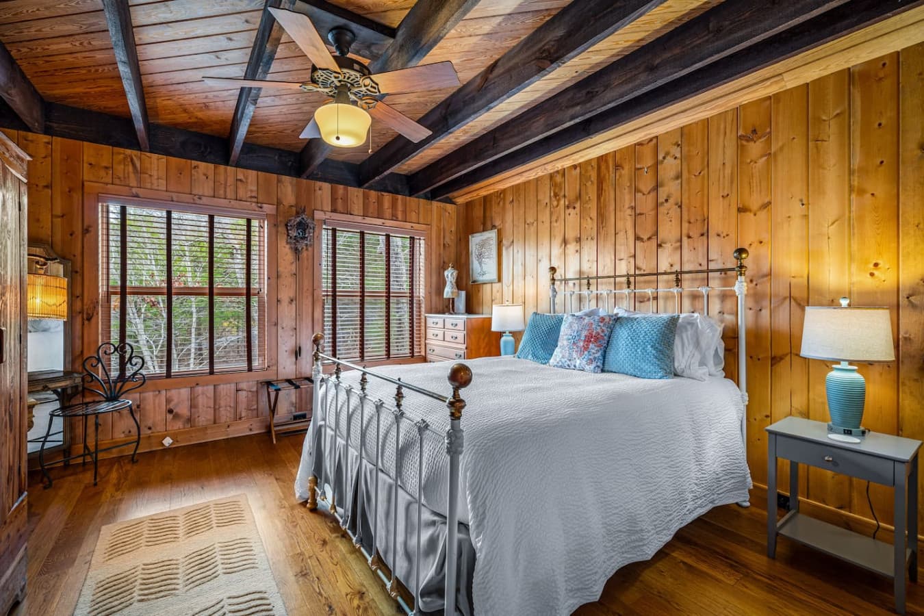 Bedroom 1 on the main floor with an attached full bathroom, featuring a cozy king bed.