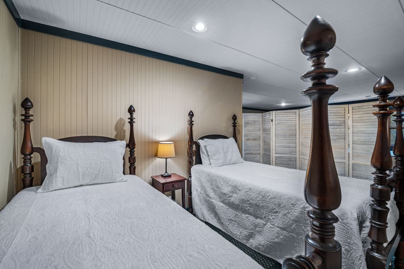 Bedroom 3 (Downstairs) featuring two twin beds, also serving as a game room separated by a divider.