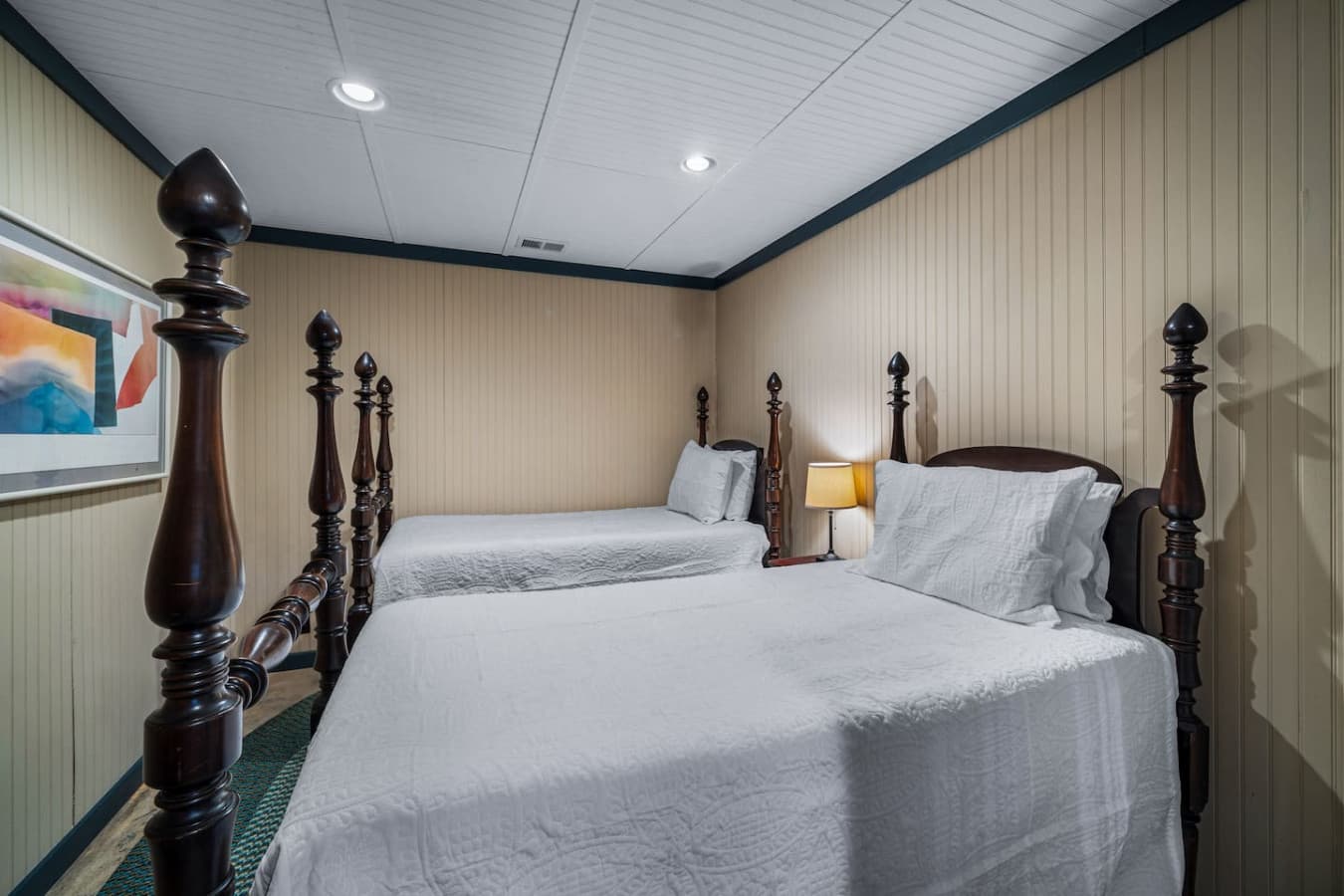 Bedroom 3 (Downstairs) featuring two twin beds, also serving as a game room separated by a divider.