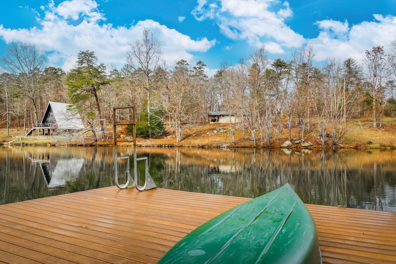 Private dock with a canoe and kayak available below the home.