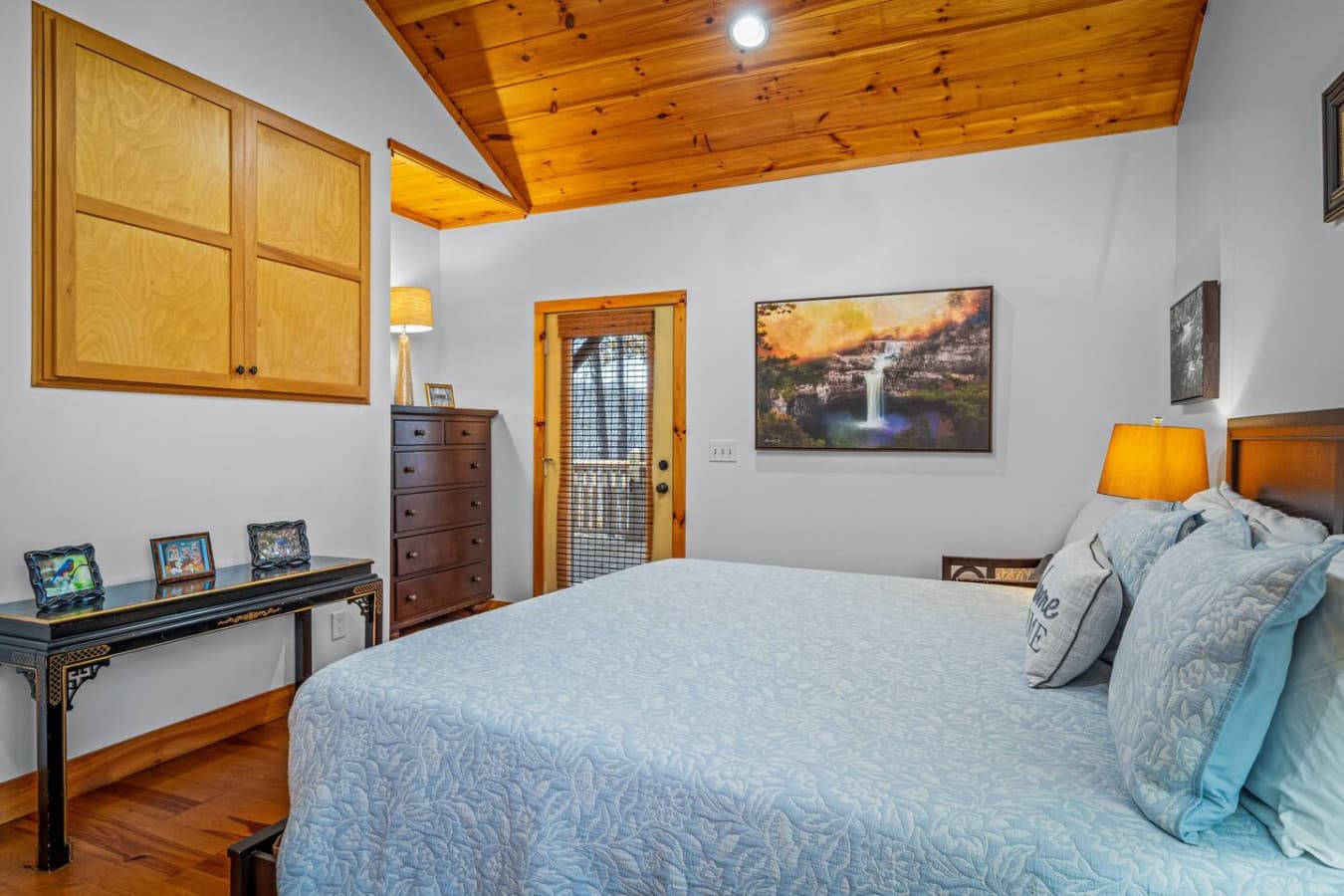 Enjoy a Smart TV hidden neatly behind cabinet doors — style meets comfort in this relaxing space.