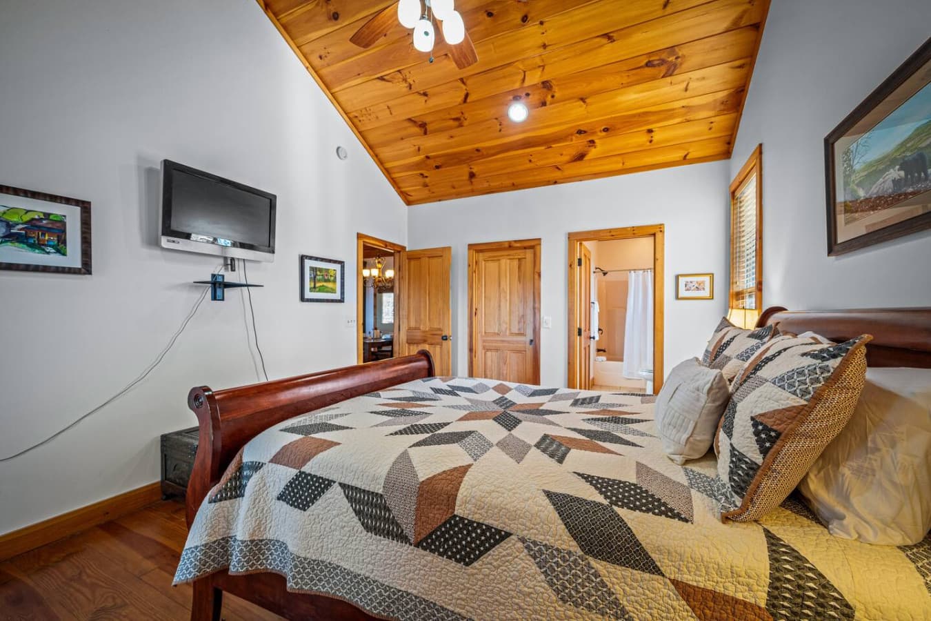 Enjoy watching your favorite shows from the TV in this bedroom.