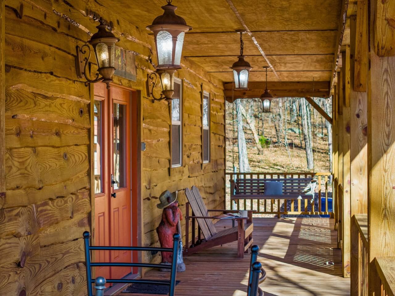 Front covered porch with a charming hanging swing — the perfect spot to relax and take in the view.