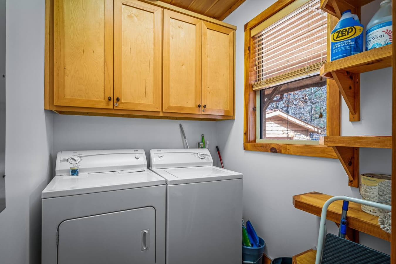 Convenient laundry area with washer, dryer, and ample storage for an extended stay.