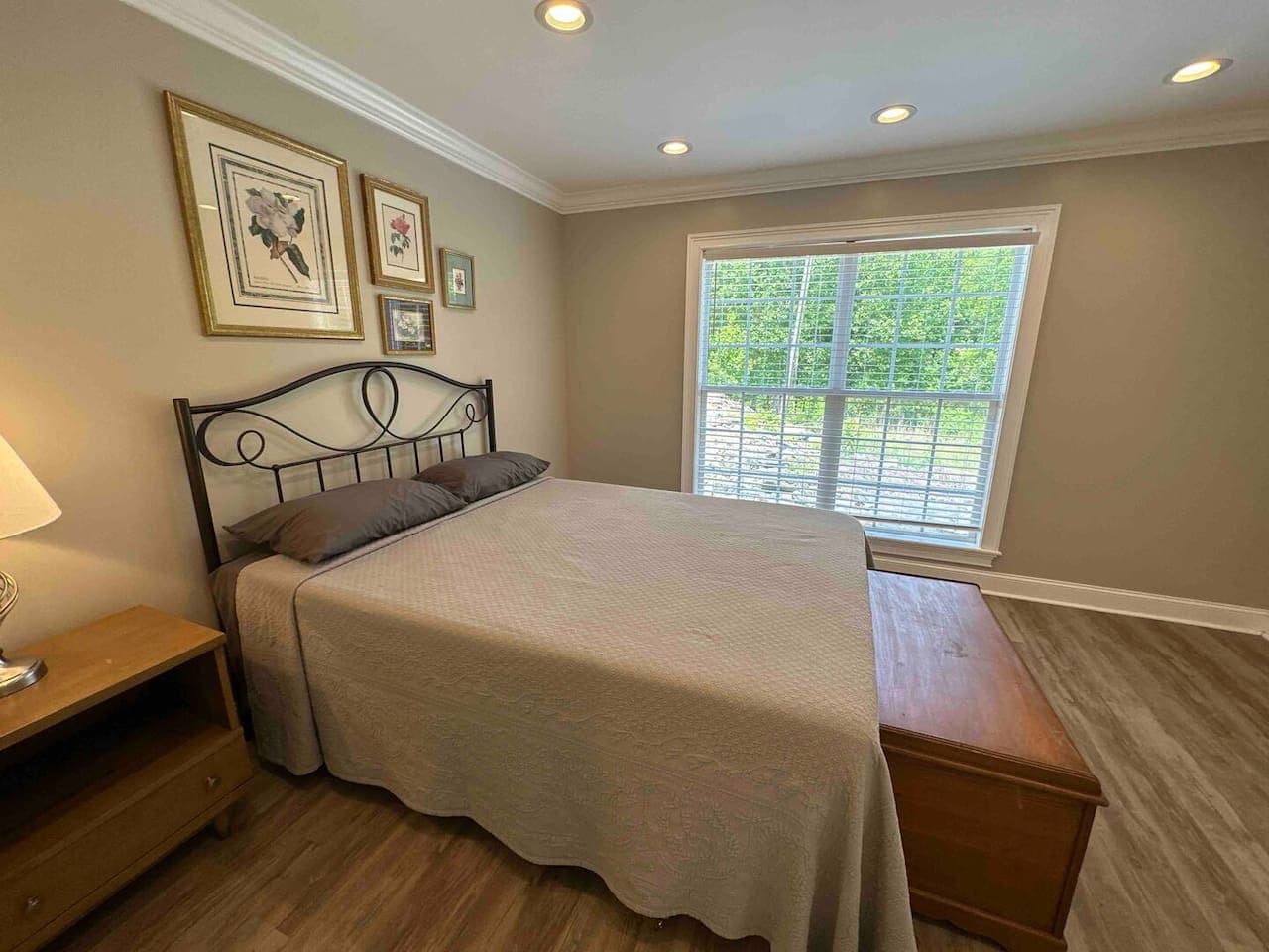 Inviting room with a queen bed, spacious closet, and convenient private bath. Bright and comfortable with warm décor and a classic wooden chest.