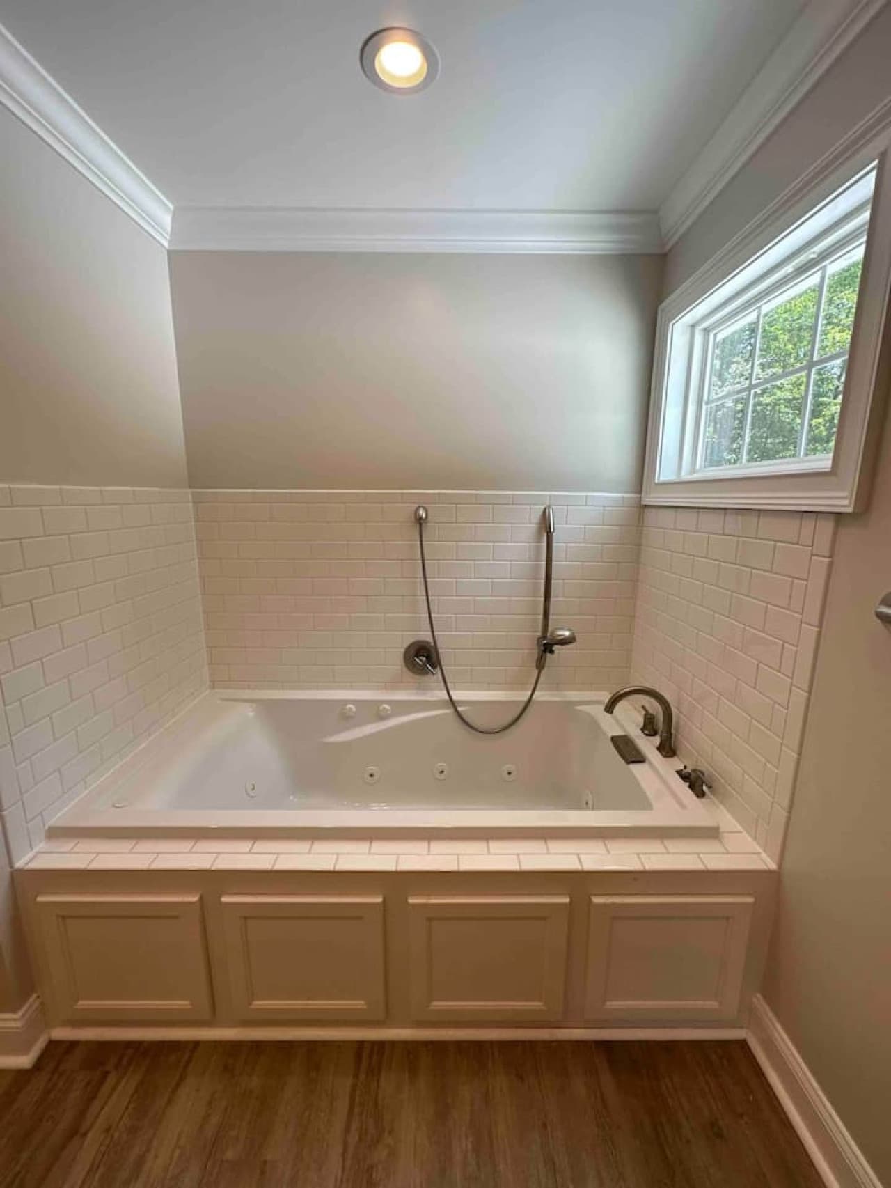 Bright and elegant bathroom with a deep soaking tub, separate walk-in shower, and stylish finishes throughout.