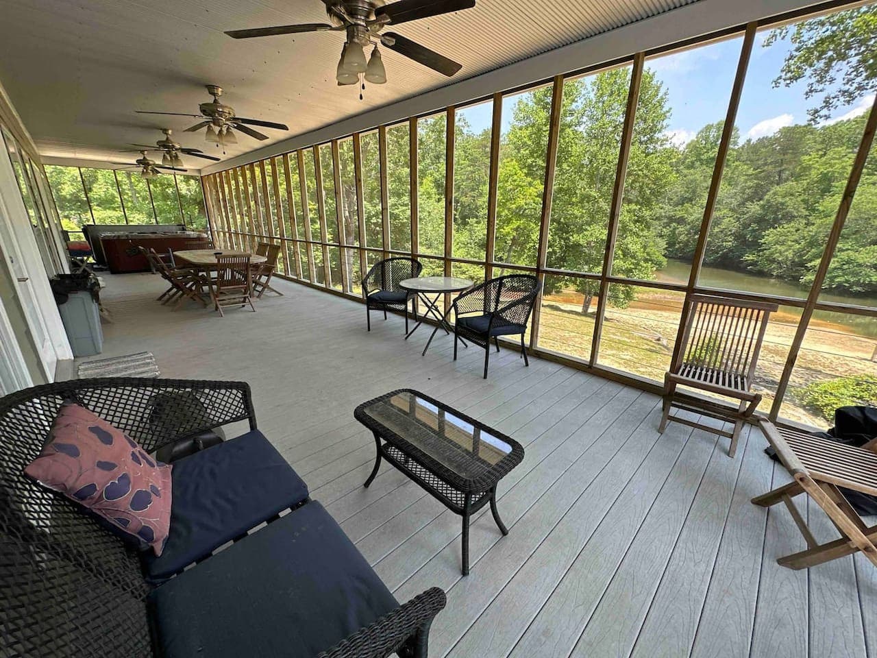 Relaxing screened porch with comfortable seating and panoramic views of the surrounding nature.