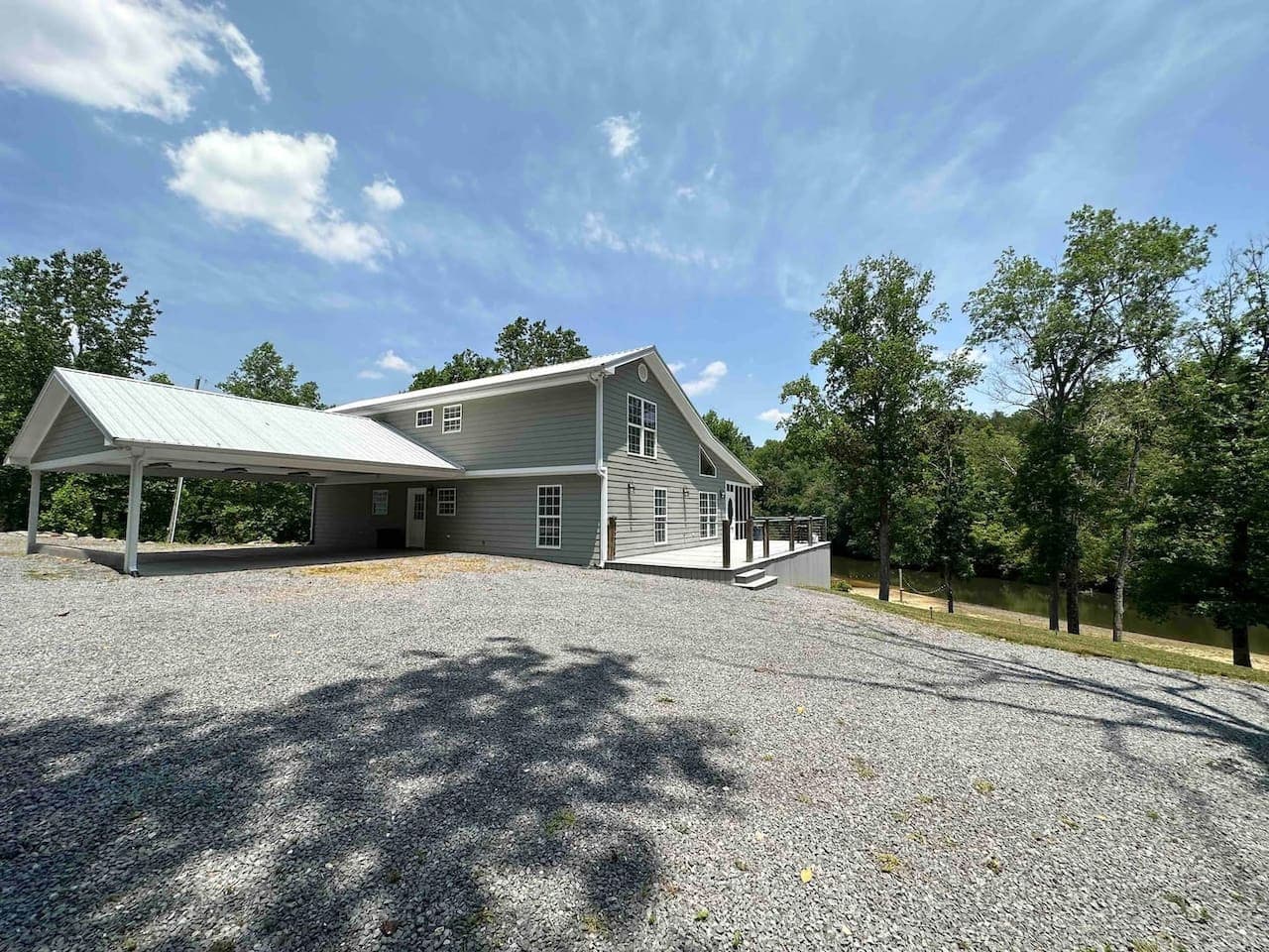 Covered carport and entryway offering convenient access and shade for guests.