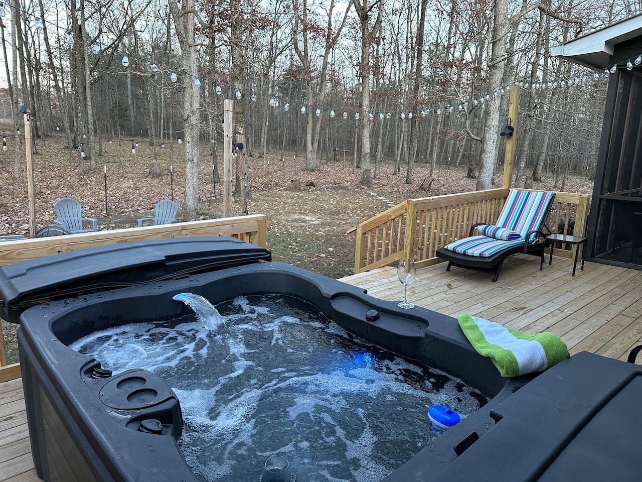 Soak in the bubbling hot tub on the large back porch, surrounded by a wooded, private setting—the perfect place to unwind, listen to nature, and relax under the stars.