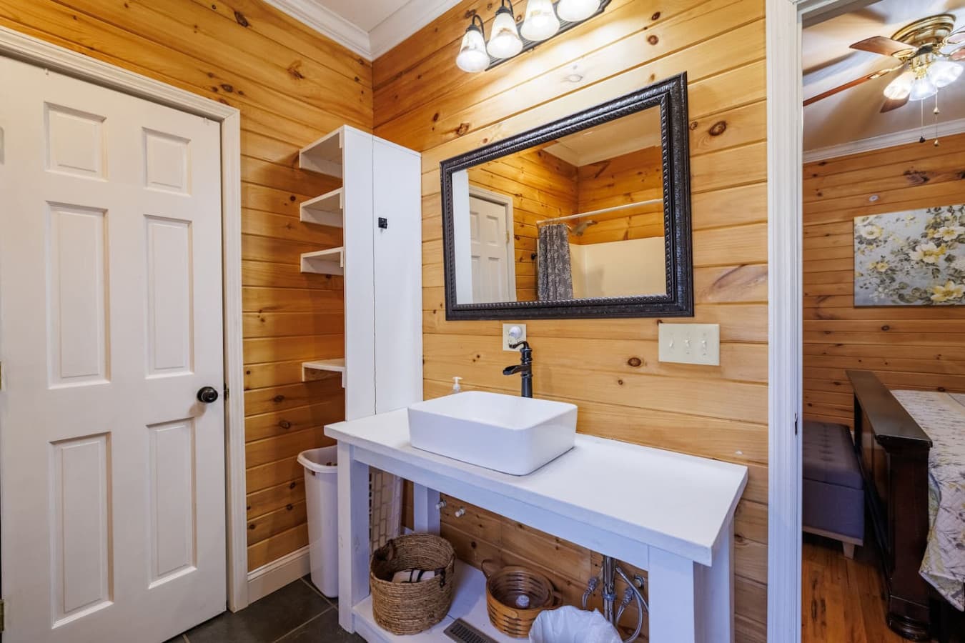 Bright vanity area with a modern sink, framed mirror, and cozy rustic touches for a refreshing start to your day.