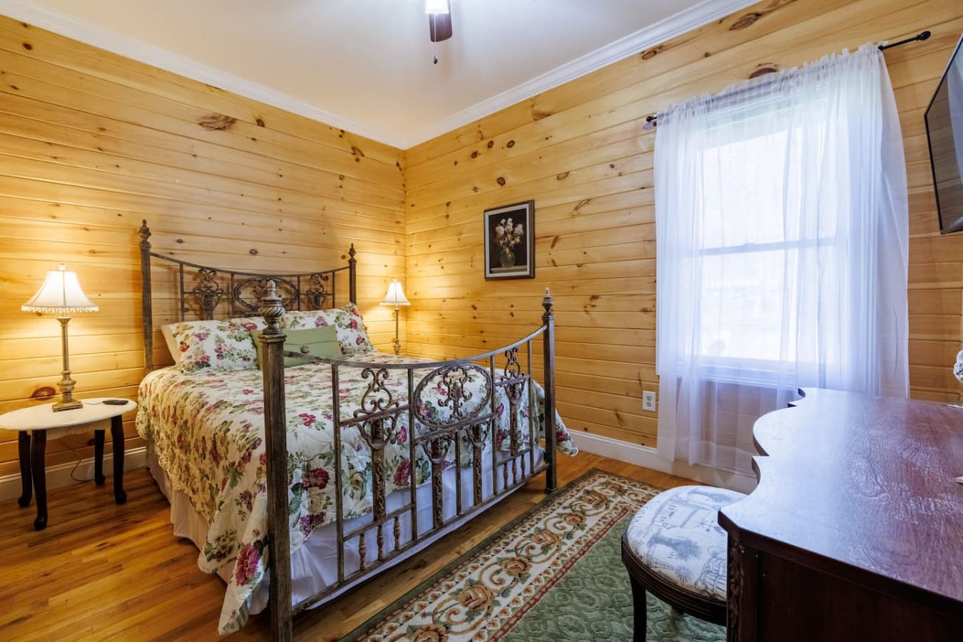 Elegant wood furnishings, and a floral bedspread that adds a touch of countryside warmth. Perfect for relaxing after a day of adventure.