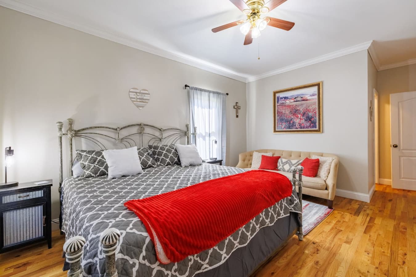 Spacious king bedroom featuring a chic accent sofa—your private retreat for relaxation, comfort, and style.